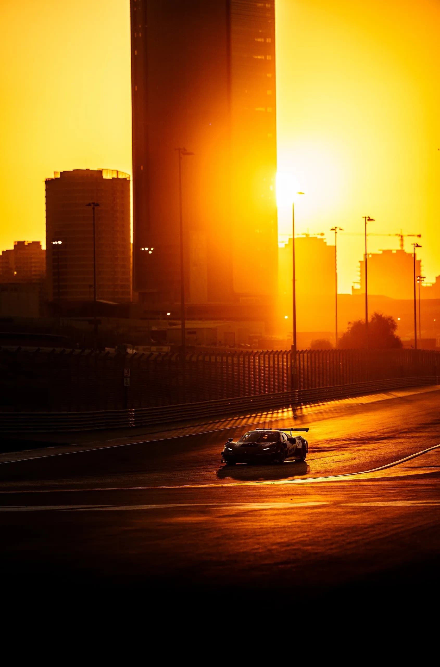 Sunset In The City - Magic of golden hour and sunsets. Race car at Dubai Autodrome.